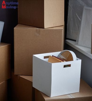 Packed moving boxes in a home, representing how much do movers cost based on volume and packing needs.